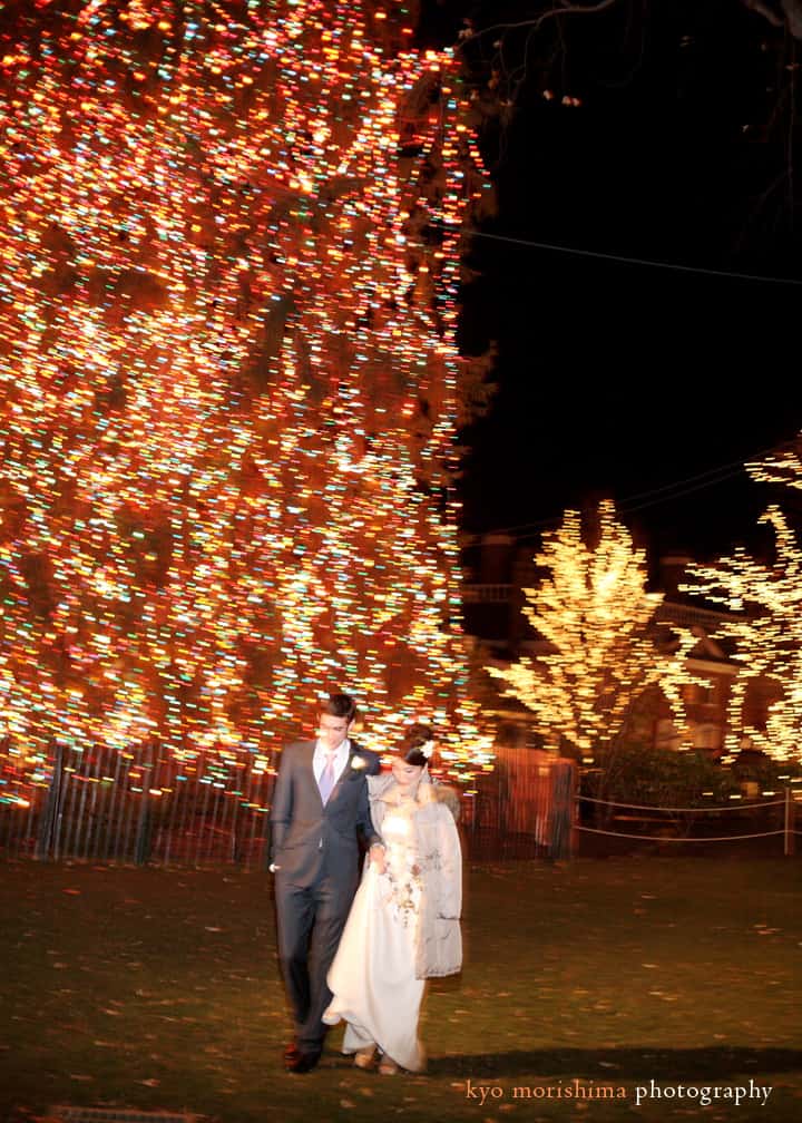 Portrait of the bride and groom near Palmer Square's Christmas lights in Princeton, photographed by Kyo Morishima.