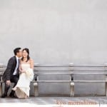 Bride and groom on playground bench in Soho, NYC, shot by NY wedding photographer Kyo Morishima.