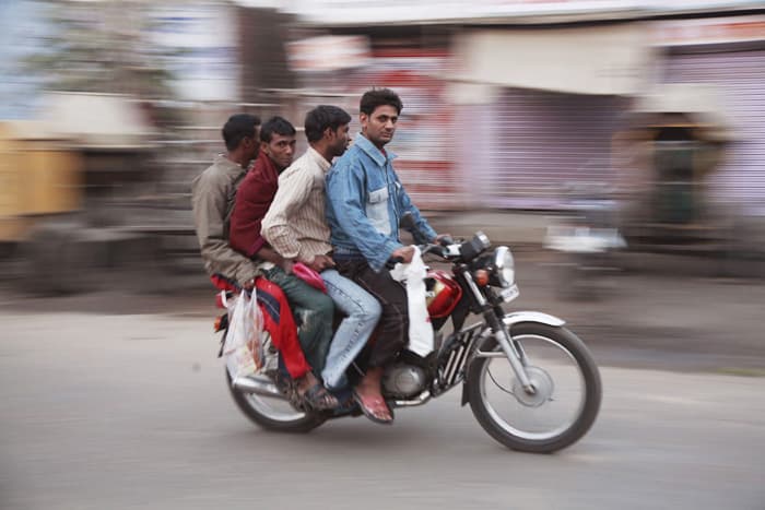 Sideways on a scooter in India, photographed by Kyo Morishima