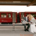 Bride and groom read newspaper in Switzerland, by destination wedding photographer Kyo Morishima