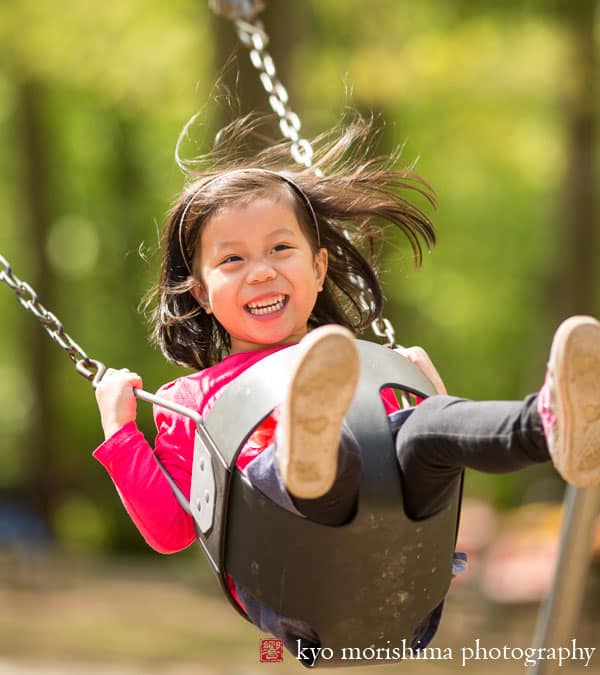 Child on swing in Roosevelt Park, Edison, by Metuchen family photographer Kyo Morishima
