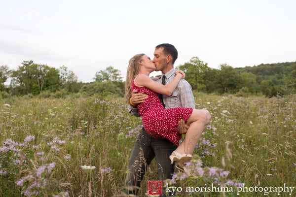 Man kissing woman in a wildflower meadow: Kittatinny State Park engagement pictures by central NJ wedding photographer Kyo Morishima