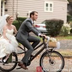 Bride and groom on bicycle after St Thomas the Apostle wedding ceremony, photographed by NJ wedding photographer Kyo Morishima.
