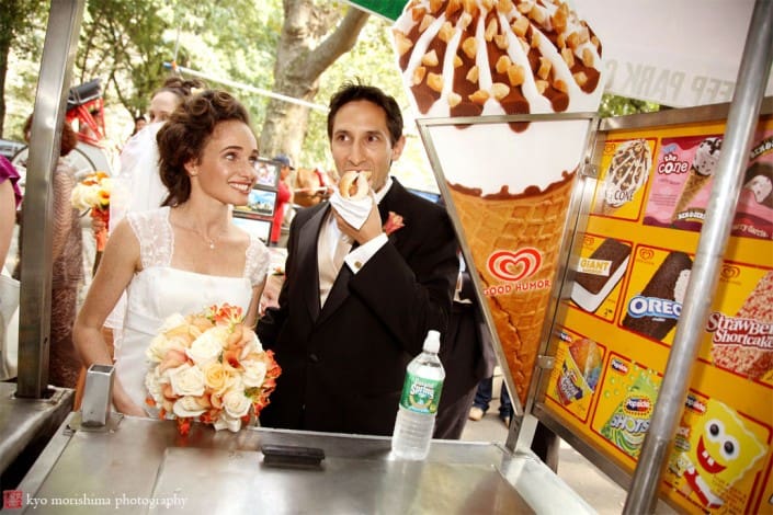 Bride and Groom eating hot dog in Central Park, NYC, photographed by Kyo Morishima