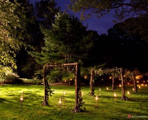 Candles light the path to a backyard wedding designed by Food Company Catering, photographed by Kyo Morishima