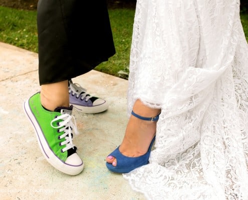 Bride wearing L.K. Bennett blue heels with Inbal Dror wedding dresses poses with guest wearing mismatched color sneakers, photographed by Kyo Morishima