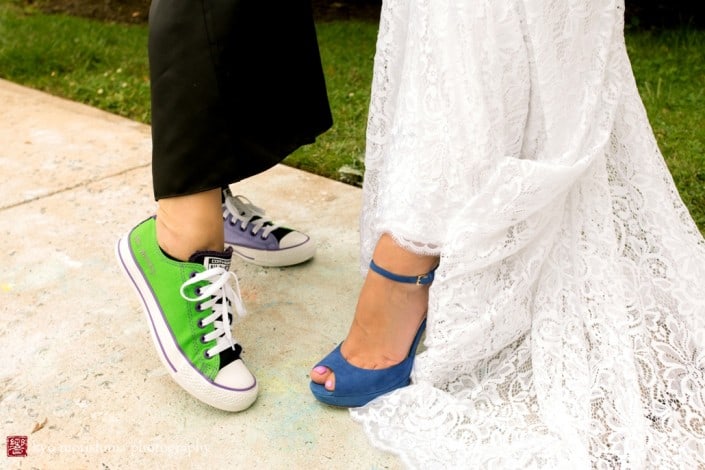Bride wearing L.K. Bennett blue heels with Inbal Dror wedding dresses poses with guest wearing mismatched color sneakers, photographed by Kyo Morishima
