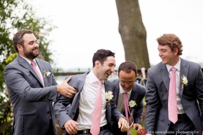 Groomsmen wearing pink ties tackle the groom, photographed by Kyo Morishima