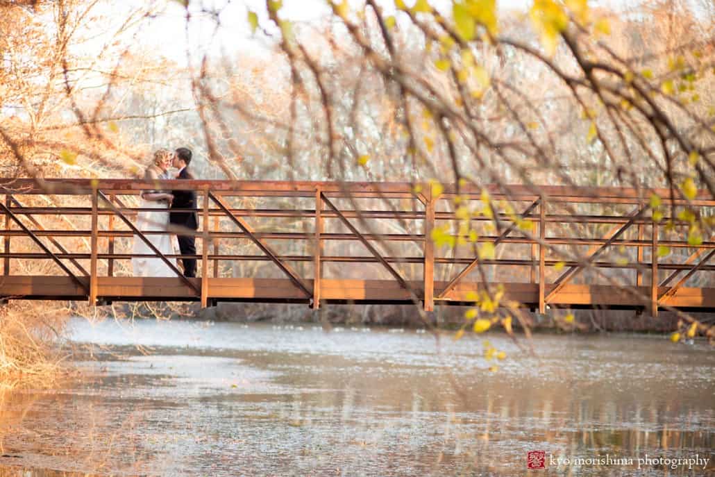 Wedding portrait on a bridge at New Jersey Audubon Plainsboro Preserve photographed by Kyo Morishima