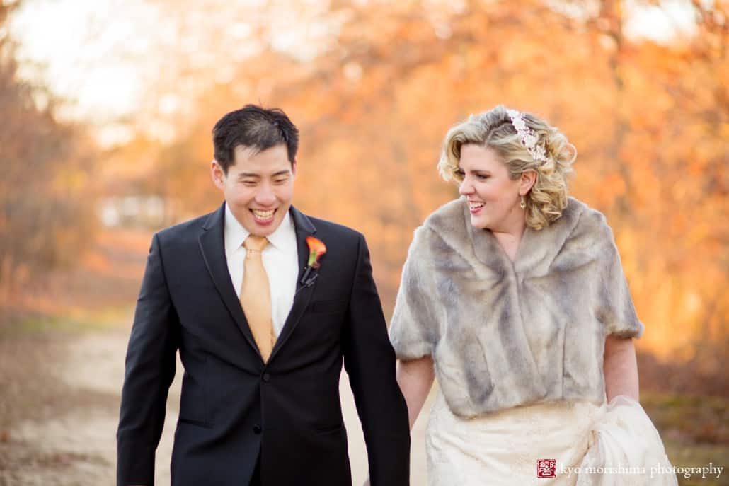 Bride and groom laugh with fall leaves in background during wedding portrait session at New Jersey Audubon Plainsboro Preserve, photographed by Kyo Morishima