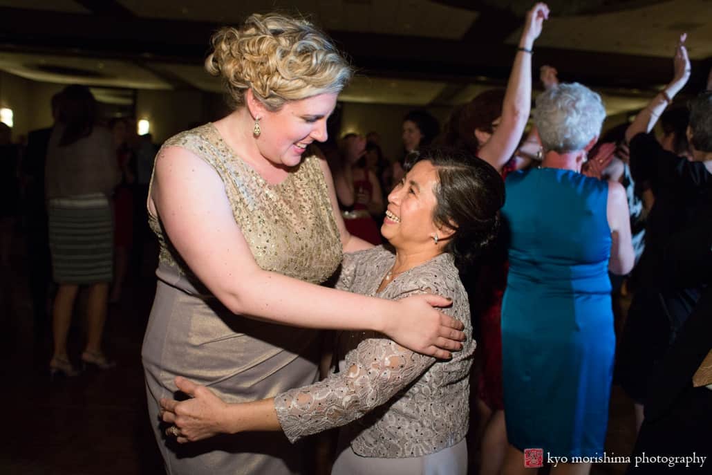 Bride embraces mother of the groom at Westin Forrestal Village in Princeton, photographed by wedding photographer Kyo Morishima