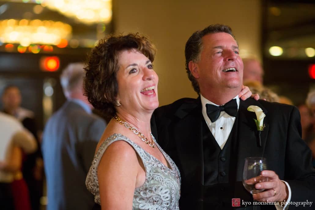 Parents of the bride smile and laugh during cake cutting at Westin Princeton wedding, photographed by Kyo Morishima