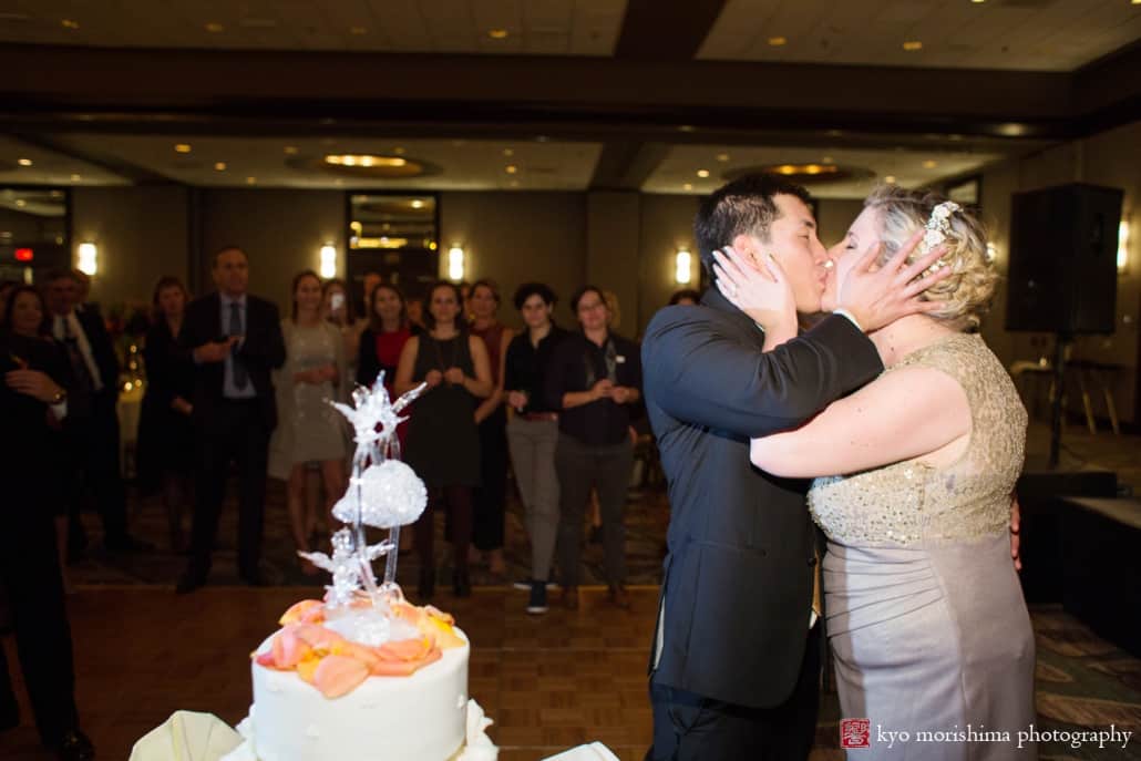Bride and groom kiss after cake cutting at Westin Princeton wedding, photographed by Kyo Morishima