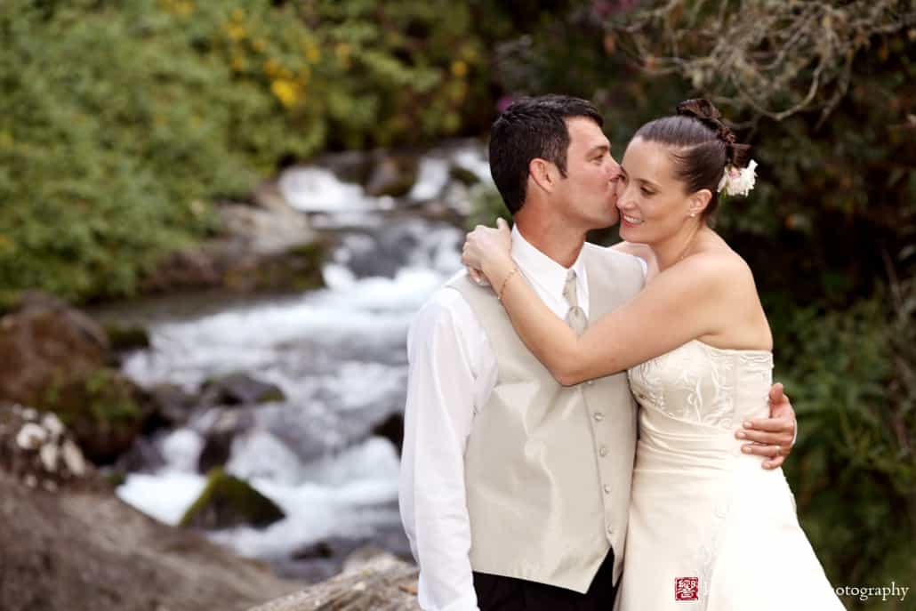 Bride and groom portrait on riverbank in Costa Rica, photographed by Kyo Morishima