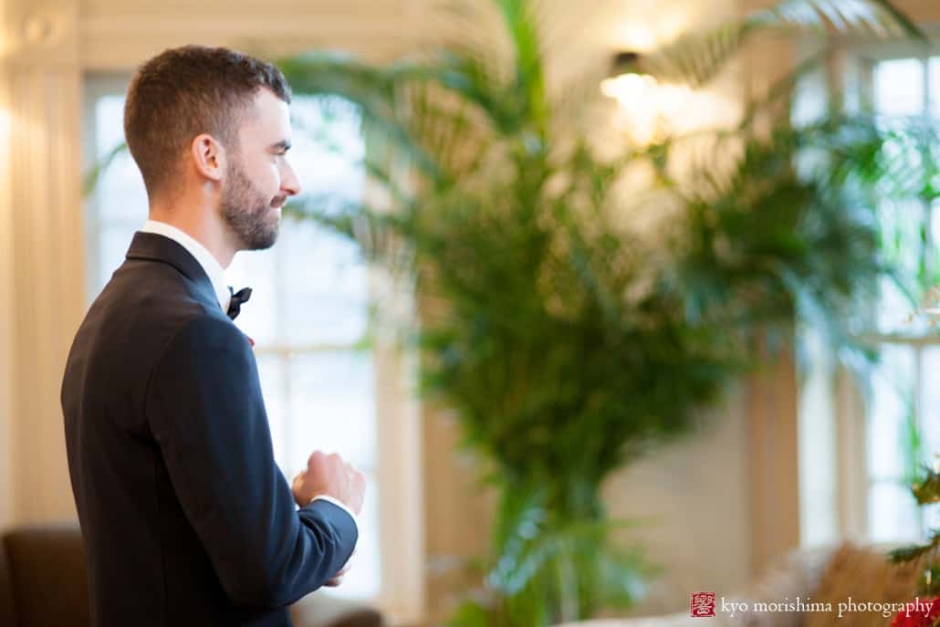 Groom awaits bride for first look in lobby of Olde Mill Inn, photographed by NJ wedding photographer Kyo Morishima