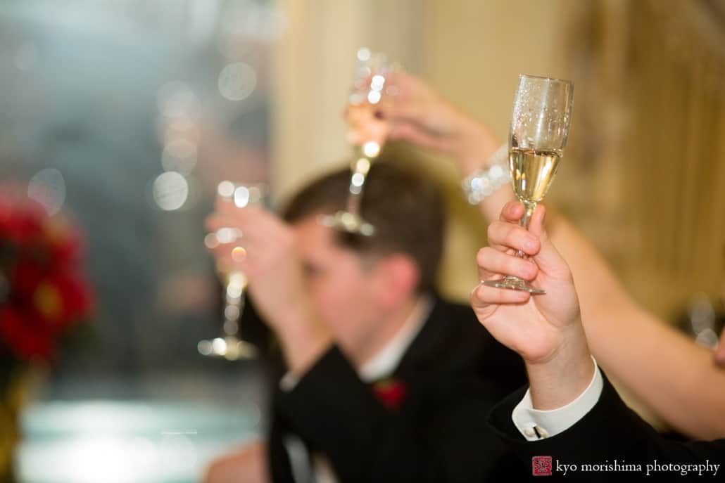 Champagne glasses raised for a toast, photographed by Basking Ridge wedding photographer Kyo Morishima