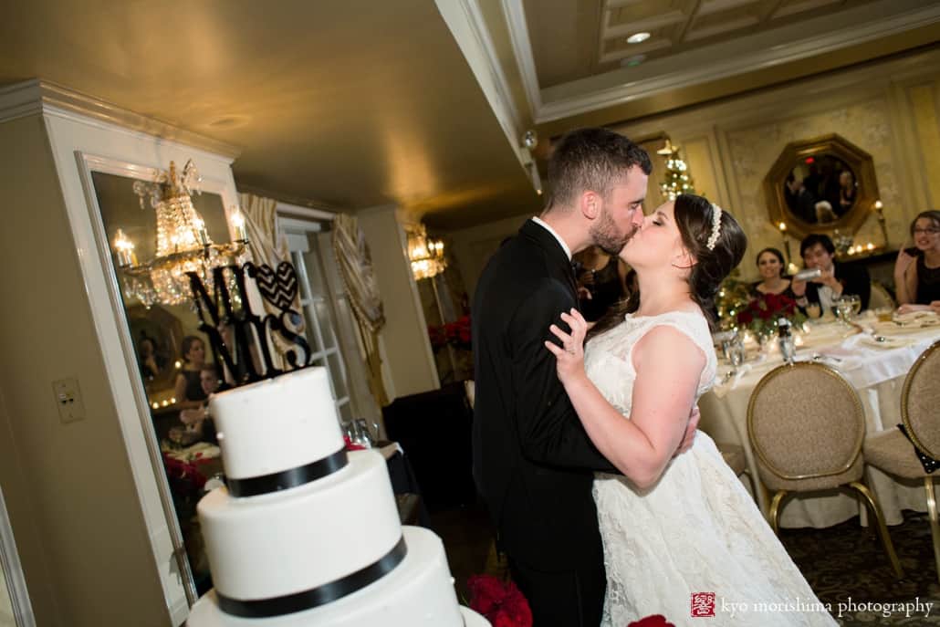 Bride and groom kiss next to cake by Palermo's Bakery, photographed by Kyo Morishima