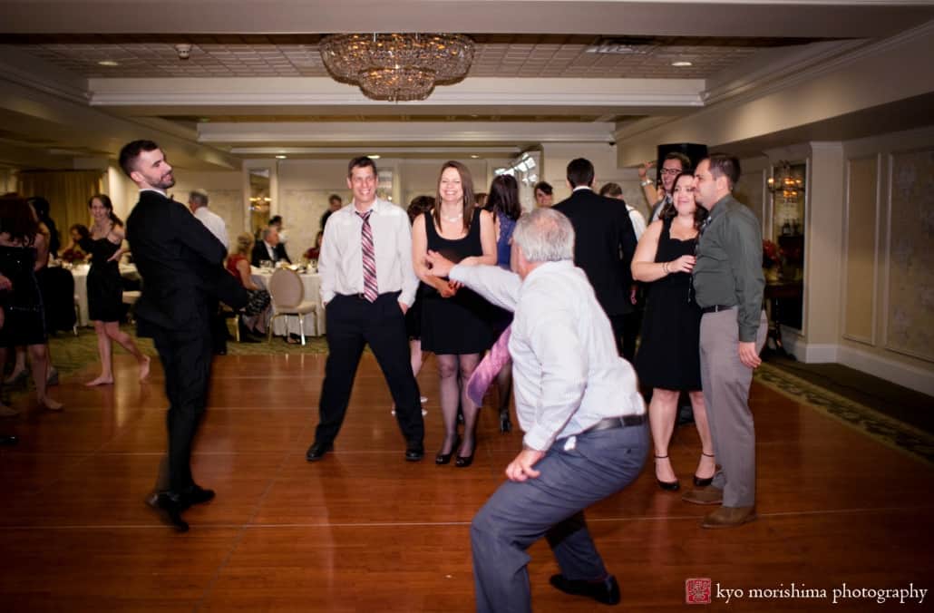Groom and wedding guest face off on the dance floor at Olde Mill Inn wedding, photographed by Kyo Morishima