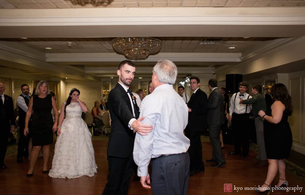 Groom and wedding guest face off on the dance floor at Olde Mill Inn, photographed by Kyo Morishima