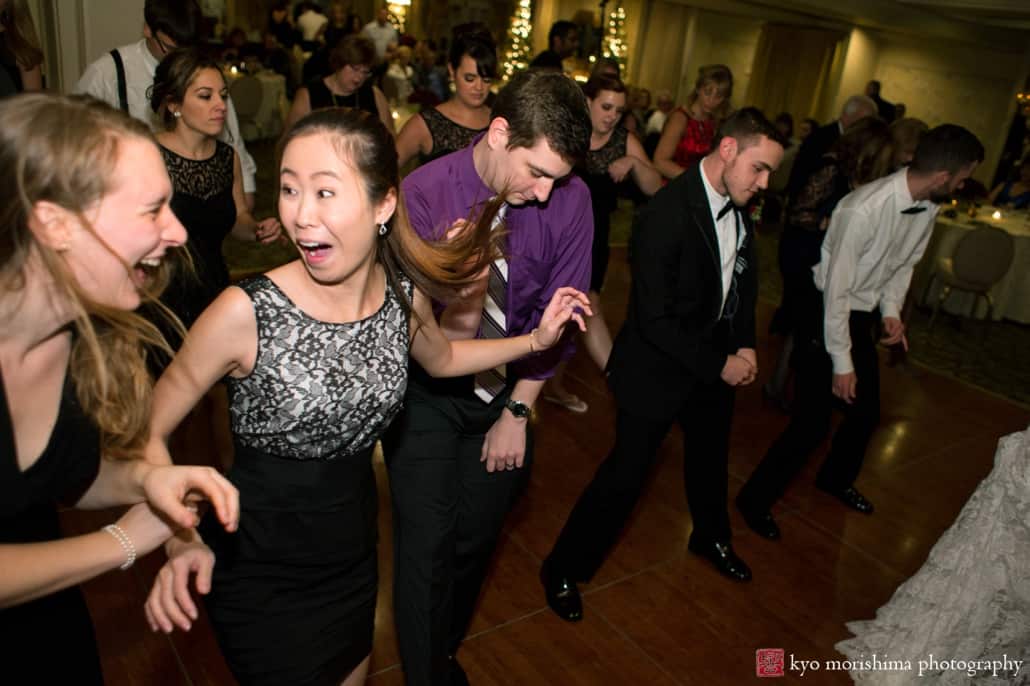 Wedding guests laugh on the dance floor at Olde Mill Inn wedding, photographed by Kyo Morishima