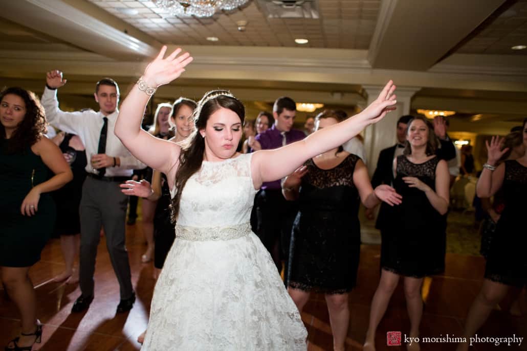 Bride dances with her arms in the air at Basking Ridge wedding photographed by Kyo Morishima