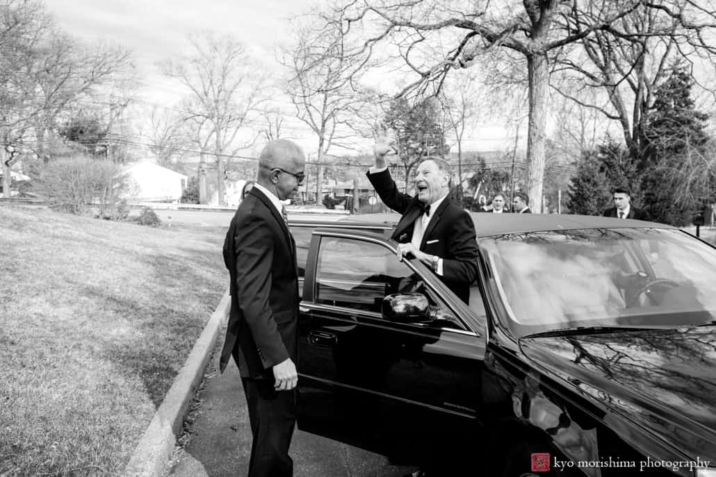 Father of the bride emerges from limo with a big smile and wave outside Holy Resurrection Orthodox Church, photographed by NJ photojournalistic wedding photographer Kyo Morishima