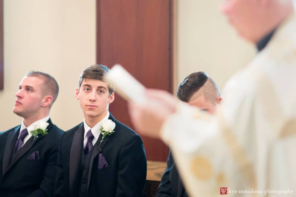 Groomsman looks at priest during Holy Resurrection Orthodox Church wedding photographed by Kyo Morishima