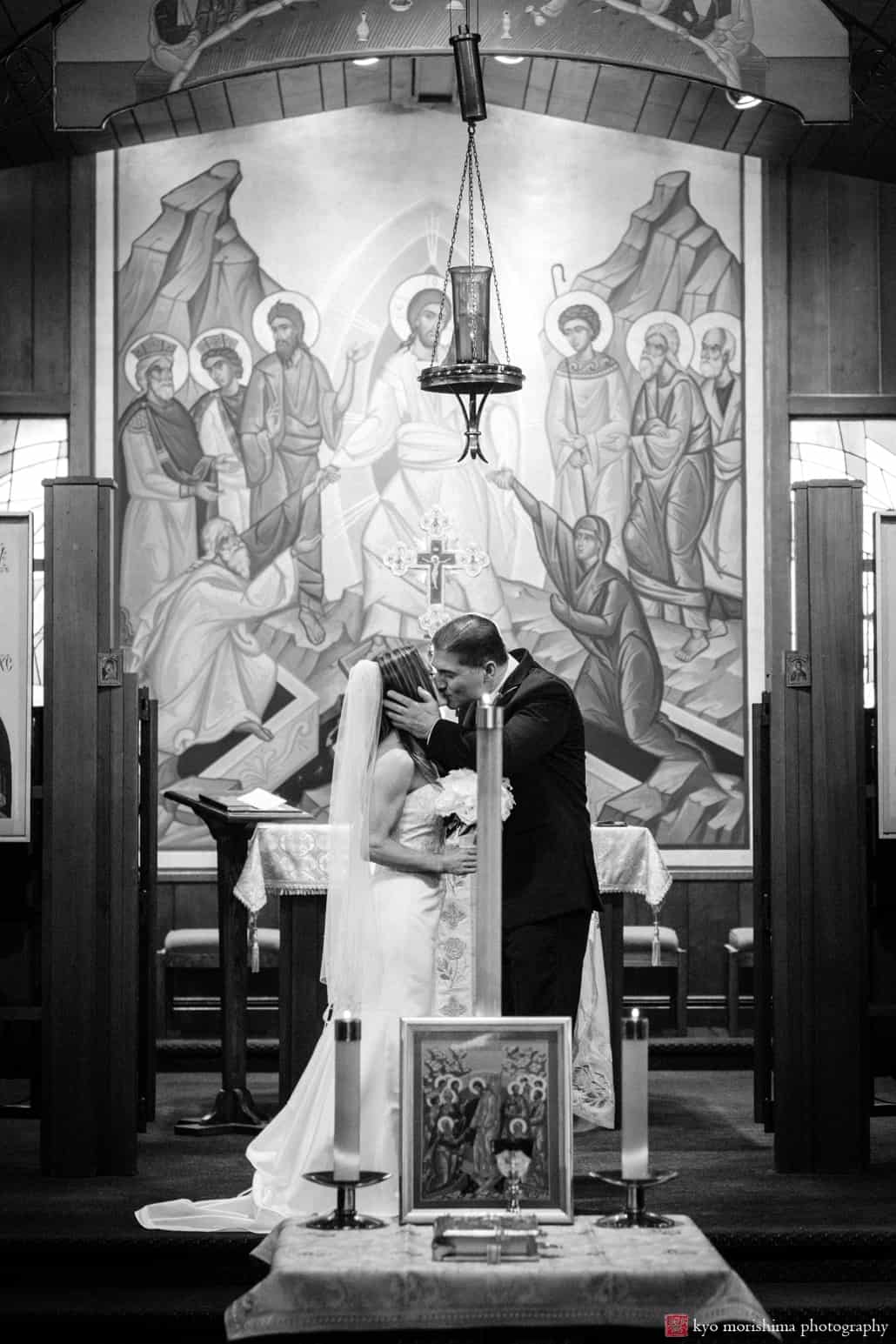 First kiss at the altar during Holy Resurrection Orthodox Church wedding photographed by Kyo Morishima