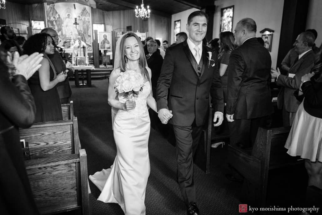 Bride and groom with big smiles as they depart Holy Resurrection Orthodox Church wedding ceremony, photographed by Kyo Morishima