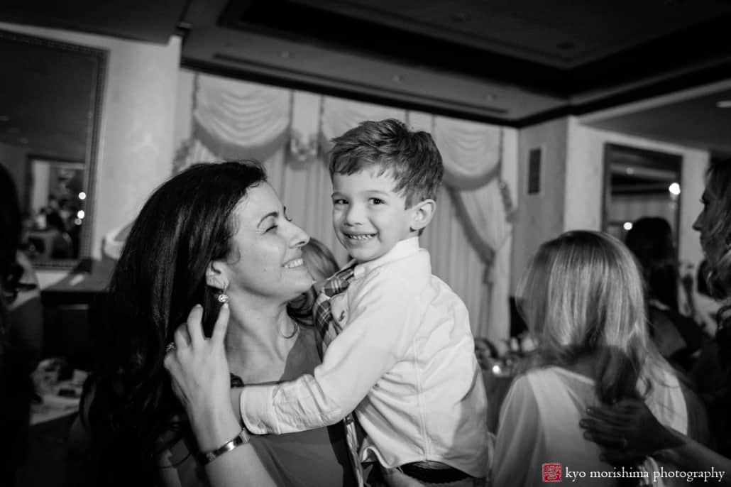 Mother and toddler pose for picture during Nassau Inn wedding reception photographed by Kyo Morishima