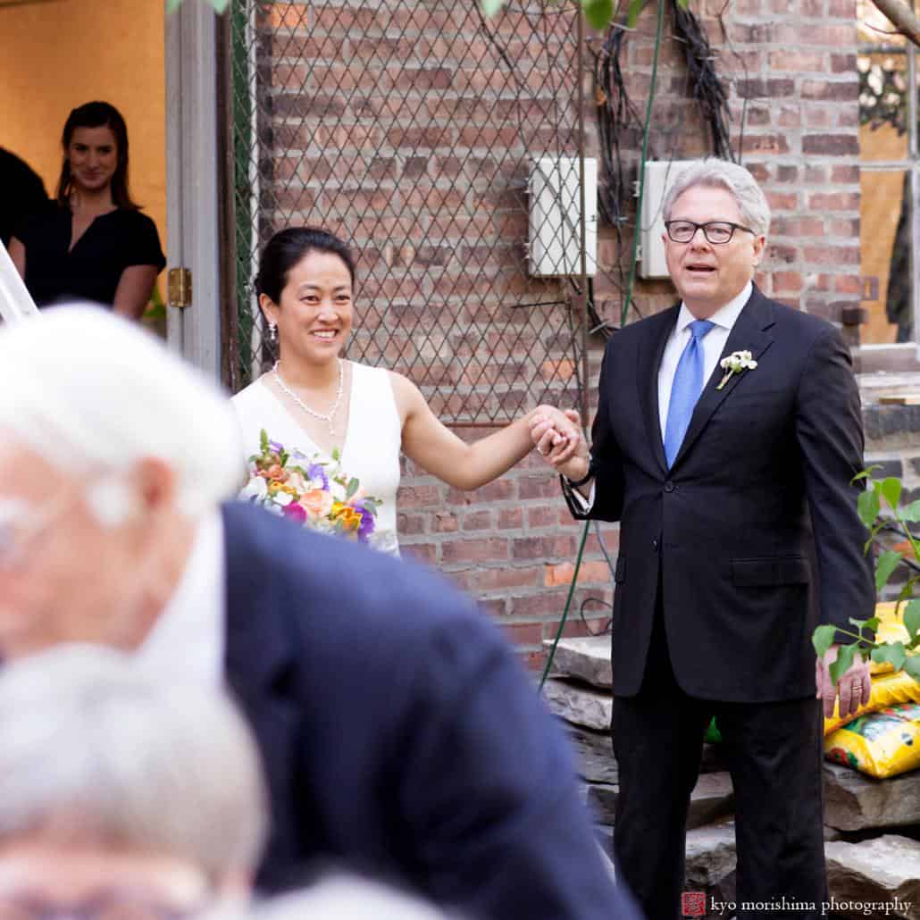 Bride and father arrive in courtyard at Invisible Dog Art Center for wedding ceremony, photographed by Kyo Morishima