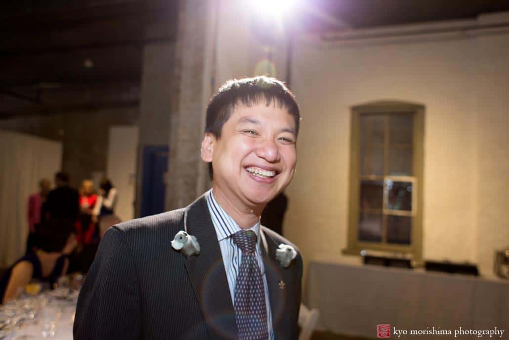 Guest grins as he wears koala bears on his lapels at Invisible Dog Art Center wedding photographed by Kyo Morishima