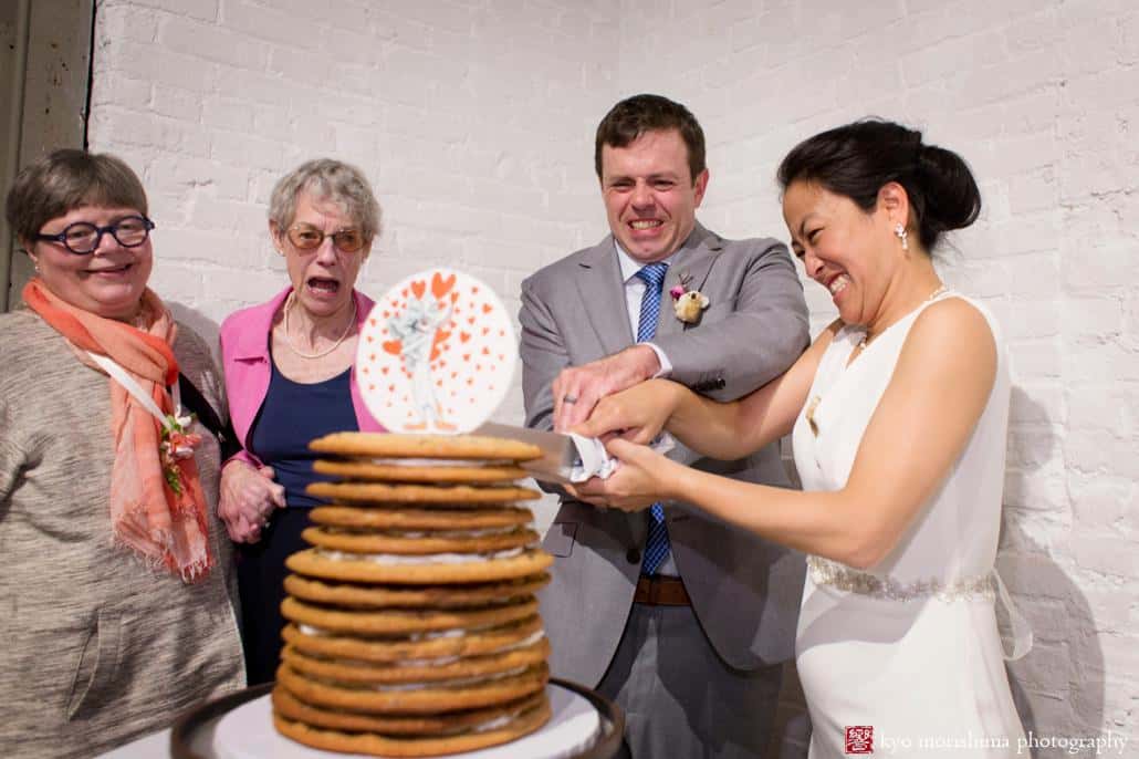Bride and groom cut their chocolate chip cookie wedding cake at Invisible Dog Art Center wedding, photographed by Kyo Morishima