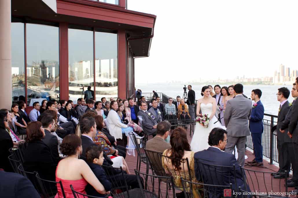 A view of guests during Chart House terrace wedding ceremony, photographed by Kyo Morishima
