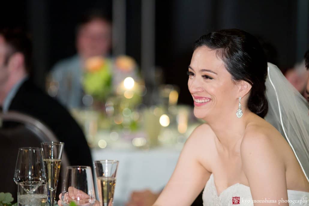 Bride laughs during toasts at Chart House wedding reception, photographed by Kyo Morishima