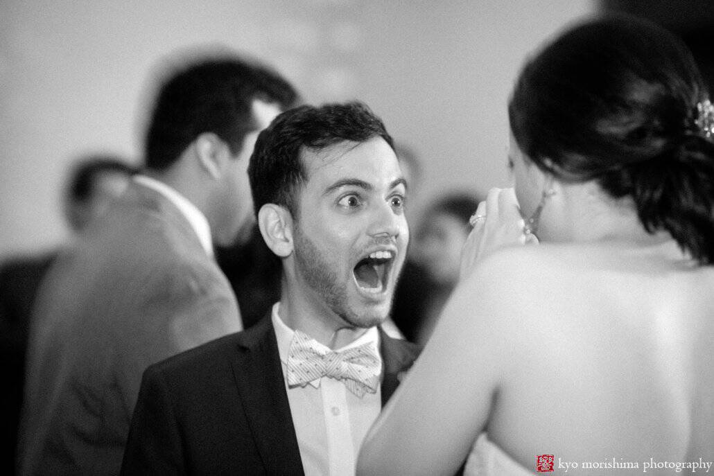 Friend of the bride greets her with great expression during Chart House wedding reception, photographed by Kyo Morishima