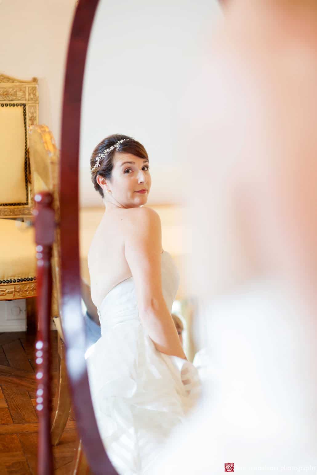 Bride glances at herself in the mirror at Jasna Polana Princeton wedding, photographed by Kyo Morishima