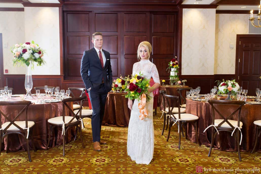 Bride and groom stand in the ballroom at Nassau Inn 