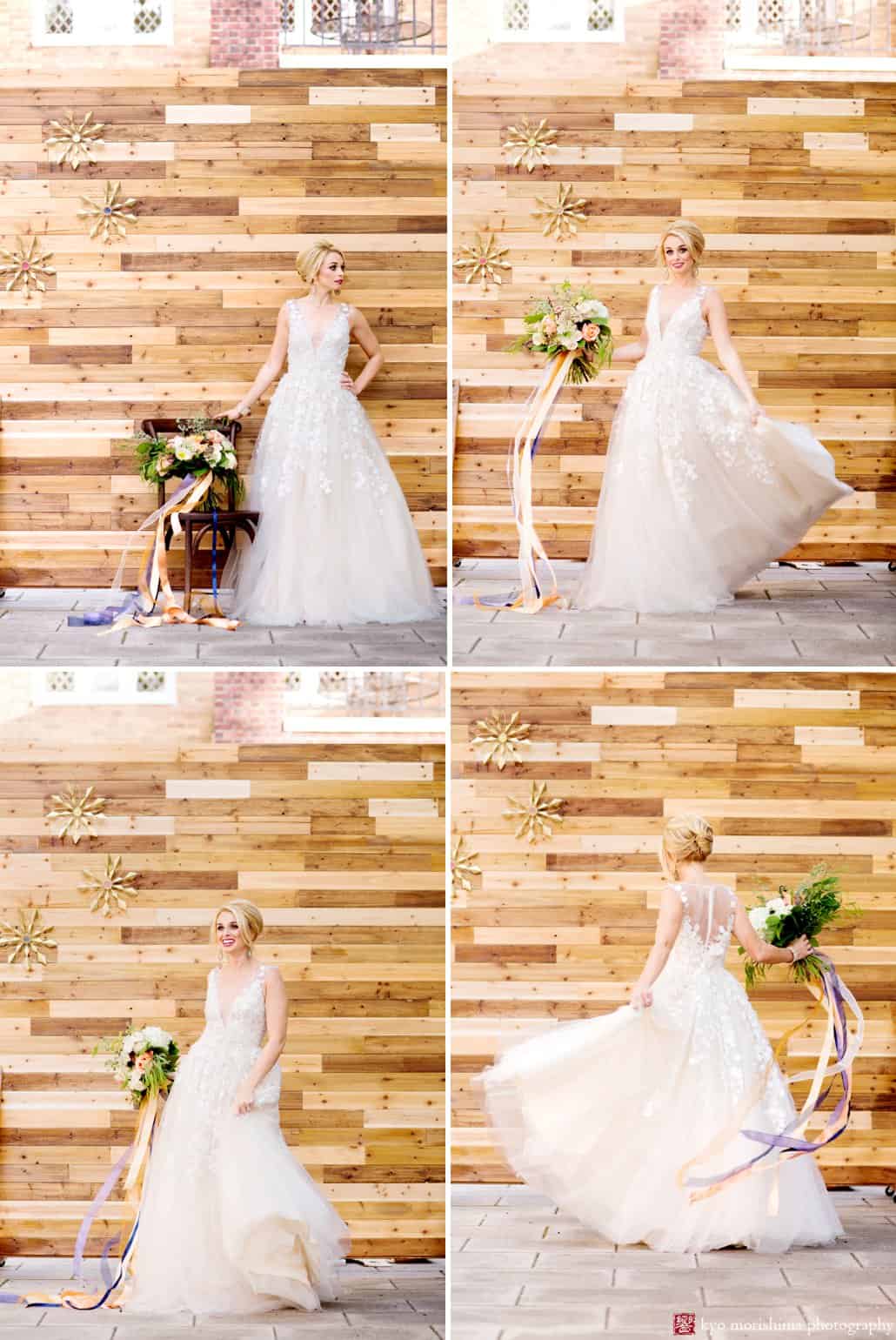 Bride wearing Ariane wedding gown from BHLDN twirls in front of wood backdrop at Nassau Inn 