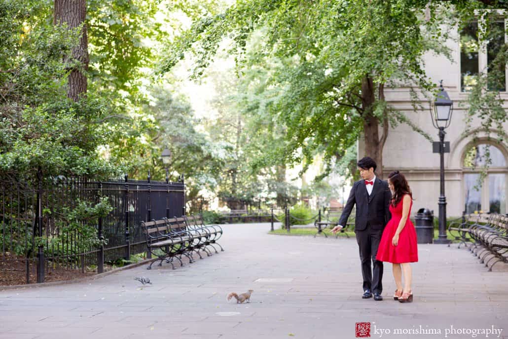 A couple look at a squirrel near City Hall in NYC, photographed by Kyo Morishima