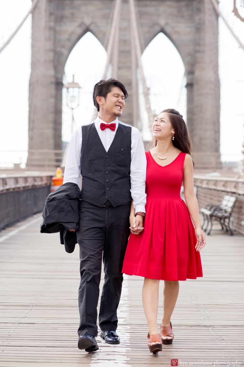 Brooklyn Bridge engagement photo with Japanese couple (woman wearing red dress, man wearing red bow tie), photographed by Kyo Morishima