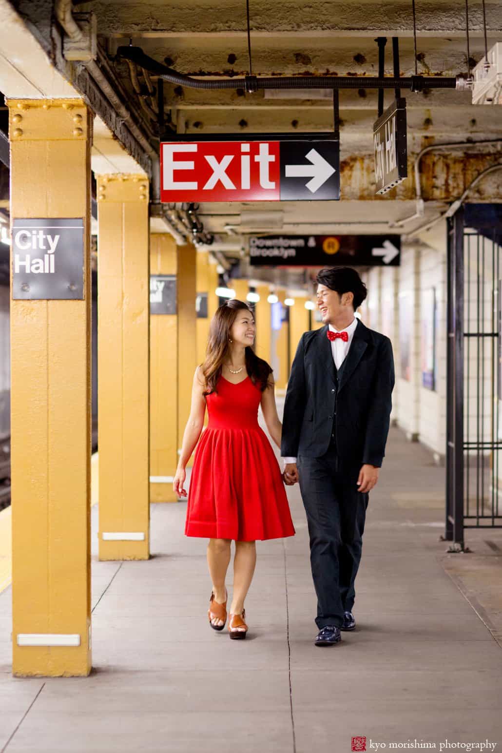 Japanese couple strolls down the platform in the NYC subway for engagement photo photographed by Kyo Morishima