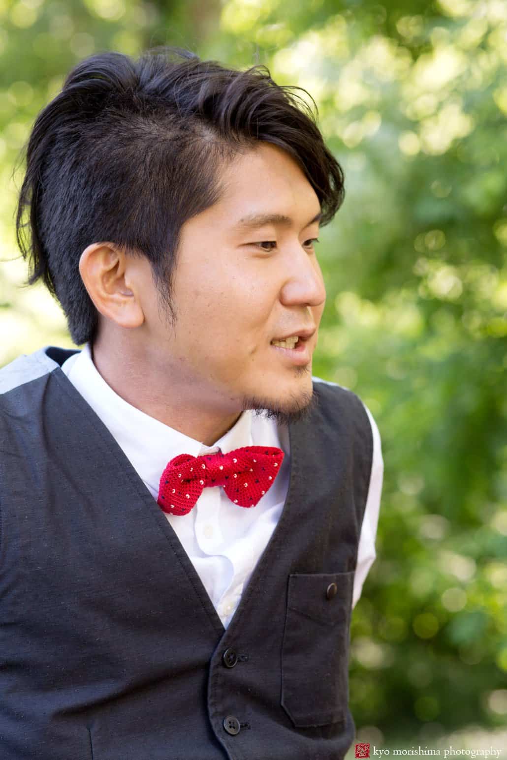 Japanese man wearing grey vest and red bow tie photographed by Kyo Morishima