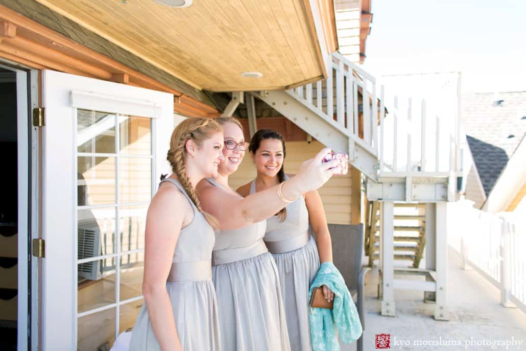 Bridesmaids snap a picture of themselves at Ocean Plaza Hotel before Asbury Park wedding, photographed by Kyo Morishima