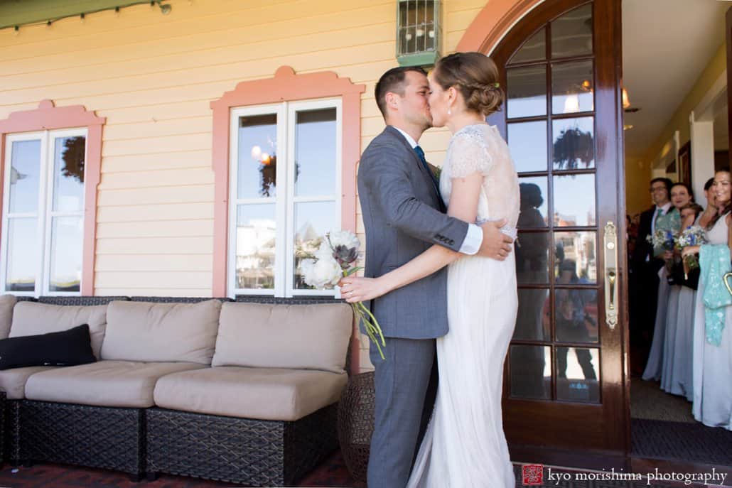 Bride and groom embrace on Ocean Plaza Hotel front porch, photographed by Asbury Park wedding photographer Kyo Morishima