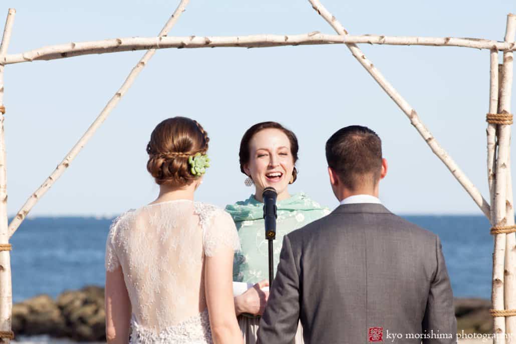 Bride and groom listen during Asbury Park beach wedding ceremony, photographed by Kyo Morishima