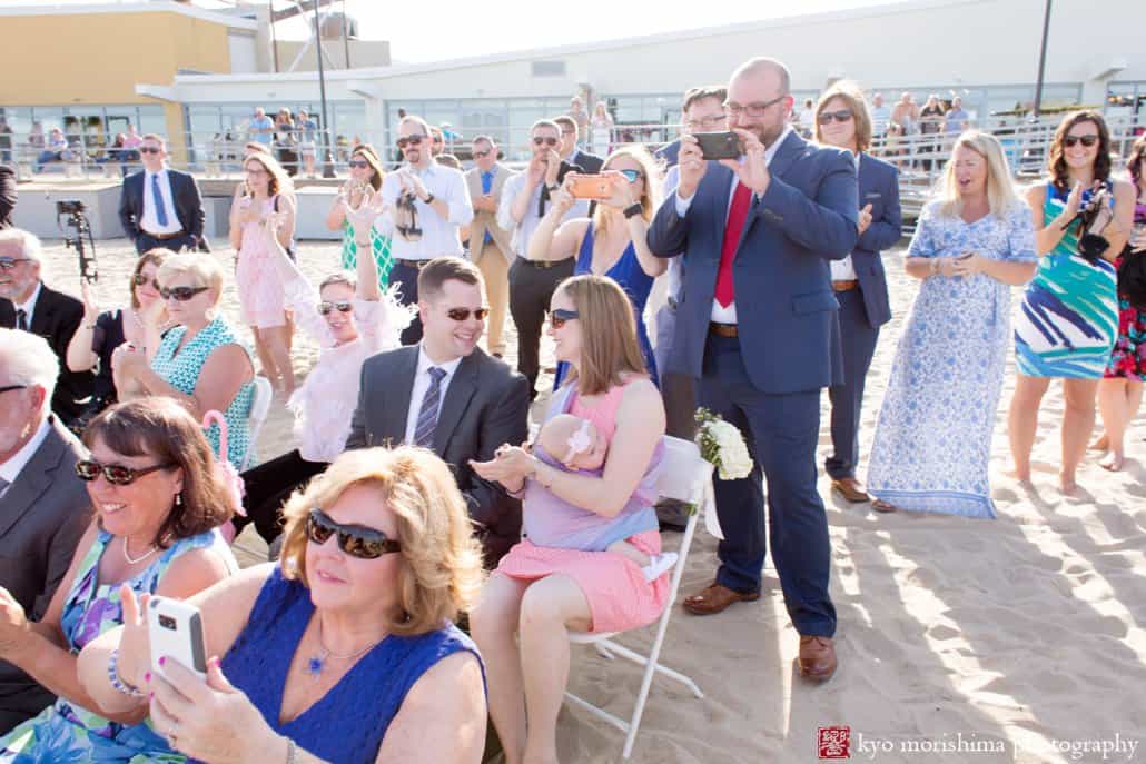 Guests applaud at end of Asbury Park beach wedding ceremony ends, photographed by Kyo Morishima