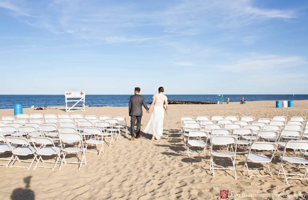 Bride and groom approach ocean after Asbury Park beach wedding ceremony photographed by Kyo Morishima