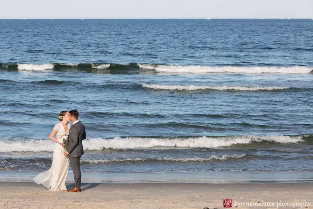 Bride and groom kiss near the water after Asbury Park beach wedding ceremony photographed by Kyo Morishima