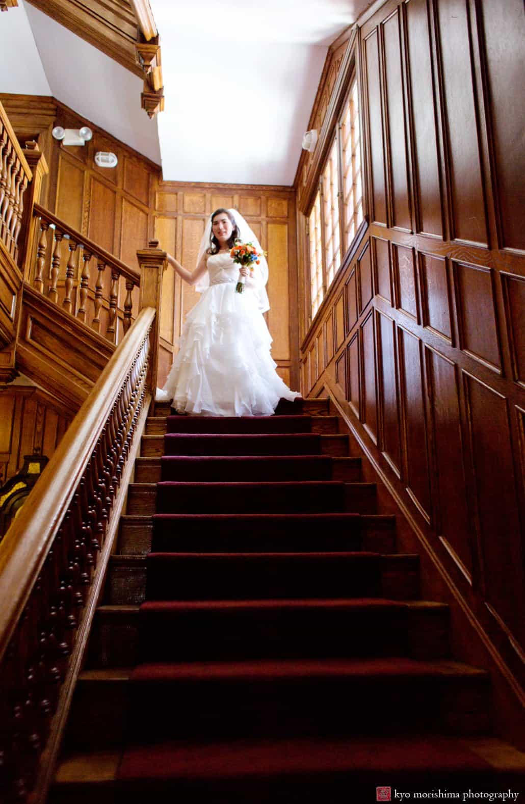 Bride descends the staircase before Princeton Cap and Gown Club wedding begins, photographed by Kyo Morishima